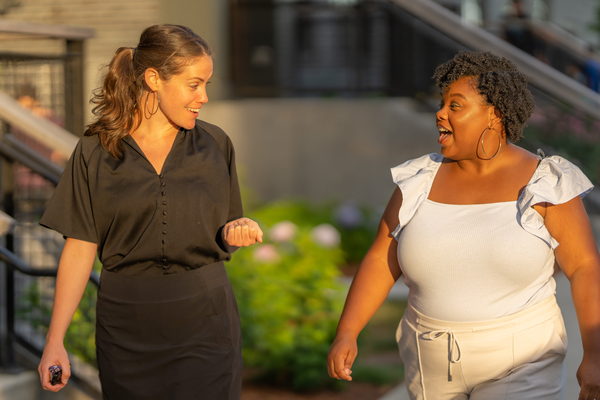 Two women talking and walking