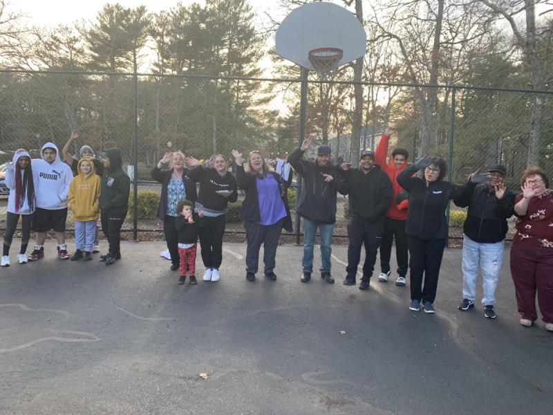 People gathered on a basketball court.